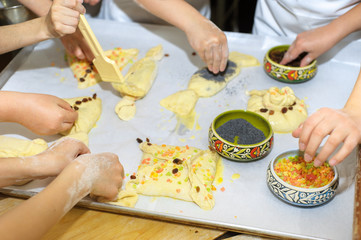 Young children make dough products. Hands closeup
