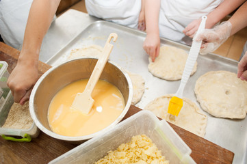 Young children make dough products. Hands closeup
