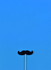 Black mustaches on light blue background representing an annual event involving the growing of mustaches during the month of November to raise awareness of men's health issues and prostate cancer