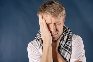 Man with cold and flu illness suffering from sore throat. Blue background