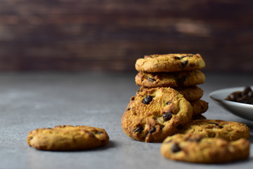 Closeup chocolate chips cookies on top of a rustic concrete table top, quick breakfast and morning freshness