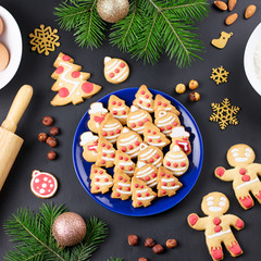 Tasty Christmas cookies, Christmas tree, decorations on black background. Christmas cooking concept