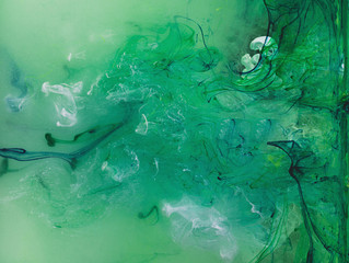 Fototapeta na wymiar Color paint drops in water. Ink swirling underwater.