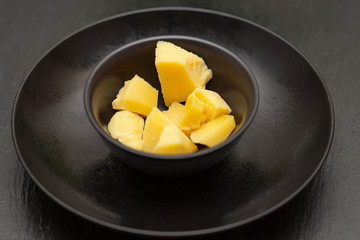 Parmesan cheese in a black bowl