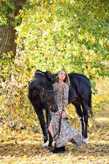 Young woman in fashion dress lead horseback