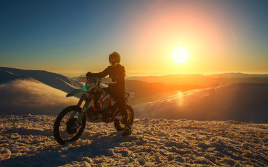Fototapeta na wymiar Motorcycle extreme sport bike winter snowy mountains