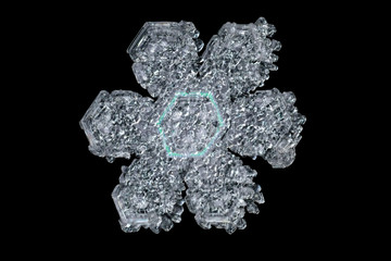 Extreme magnification - Real snowflake isolated on black background