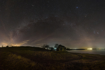 Milky way panorama over an abandoned church