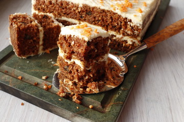 Homemade carrot cake cut into pieces.