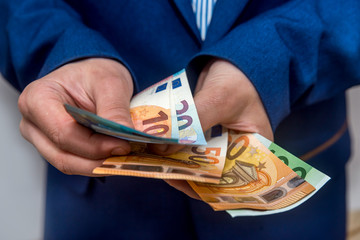 Businessman hands counting euro banknotes close up