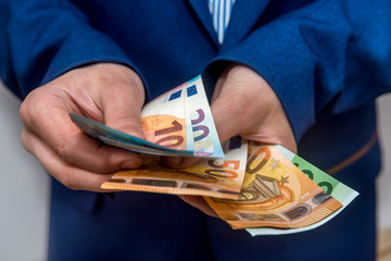 Businessman hands counting euro banknotes close up