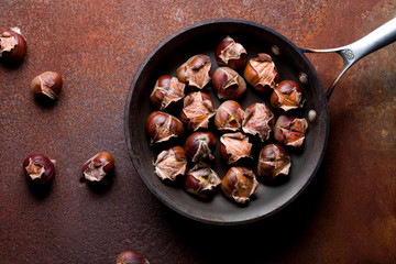 Hot baked chestnuts in a pan. View from above.