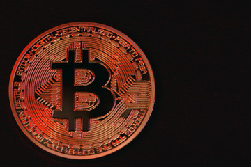 gold bitcoin against the black background
