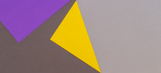 Abstract geometric paper texture cardboard background. Top view of purple violet yellow gray trendy colors tones