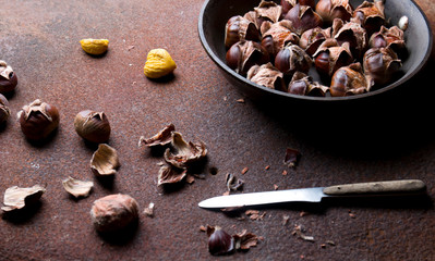 Hot baked chestnuts in a pan. View from above.
