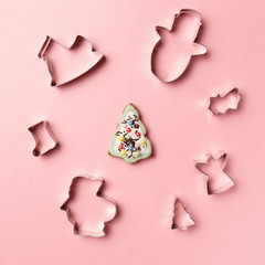 Christmas cookies various shape cutter on pink background. Top view. Flat lay. Trendy colorful photo. Minimal style with colorful paper backdrop. Christmas concept.