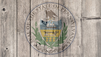 USA Politics News Concept: US State Pennsylvania Seal Wooden Fence Background