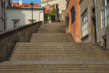 Fototapeta na wymiar Deserted street with steps leading up