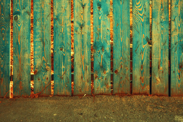 Old fence painted in teal color