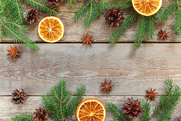 Christmas New Year composition frame with fir branch pine cones orange slices on old shabby rustic wooden background. Xmas holiday december decoration. Flat lay copy space Time for celebration concept