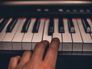 Fototapeta premium Playing on classic electrical piano keyboard