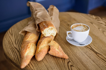 French baguettes and coffee on the wooden table	