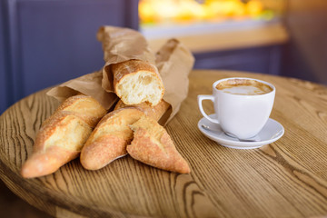 French baguettes and coffee on the wooden table	
