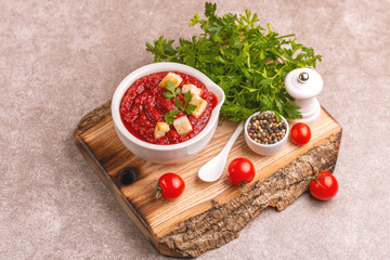 Bright fresh tasty pureed tomato soup with ingredients