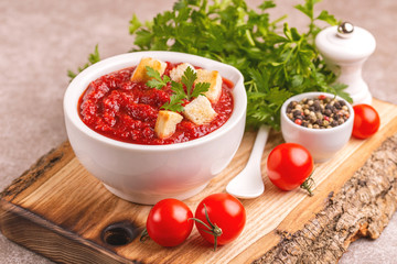 Bright fresh tasty pureed tomato soup with ingredients