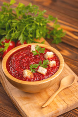 Bright fresh tasty pureed tomato soup with ingredients
