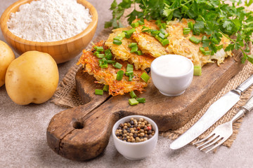 Homemade potato pancakes or latke Hanukkah celebration food with ingredients