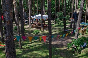 Fototapeta na wymiar Summer child public bivouac with alcove and basketball sport court or arena in the coniferous forest, near to Pasarel village, Bulgaria 