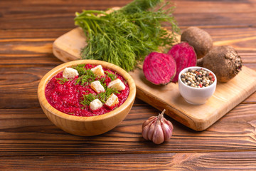 Bright tasty pureed beetroot soup with ingredients. Healthy food