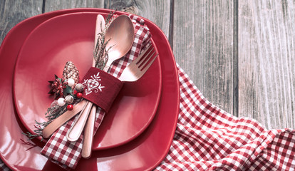 Christmas dinner cutlery with decor on a wooden background