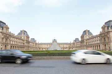cars driving past the louvre