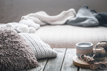 still life from home interior on a wooden background with a candle