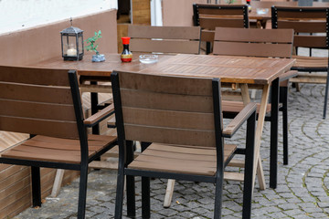 Cozy street restaurant. Tables and chairs in the street.