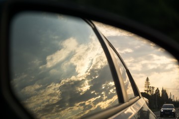 Sunset in rear car mirror. Czech Republic