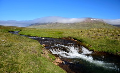 Icelandic landscape with a river and a mountain. Peninsula Skagi.