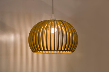 Suspended wooden lamp. Modern chandelier of wood in Scandinavian style
