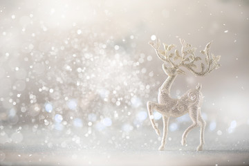 Silver glitter Christmas deer on grey background with lights bokeh, copy space. Greeting card for...