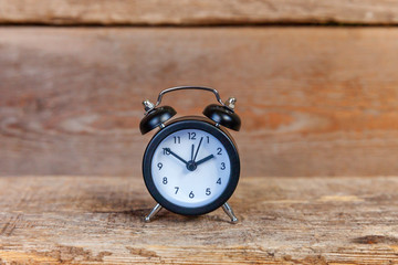 Ringing twin bell vintage classic alarm clock on old shabby rustic wooden background. Rest hours,...