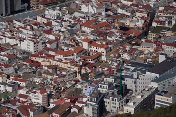 A small town from above with lots of buildings and many red rooftops.
