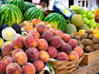 Obraz na płótnie Canvas Fruit and vegetable market in Tirana, Albania. Sunny day. peaches, watermelons