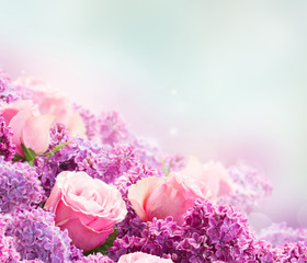 Border of purple Lilac flowers with pink roses over gray background