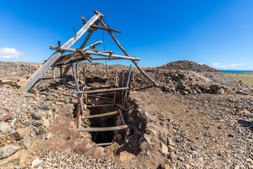 Old entrance of an abandoned open pit mine for copper extraction in Atacama Desert where almost all...