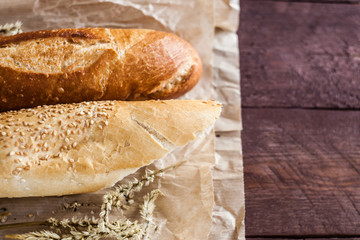 mix of different varieties of bread lying on a wooden table