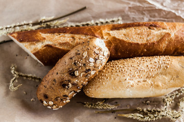 mix of different varieties of bread lying on a wooden table