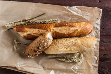 mix of different varieties of bread lying on a wooden table