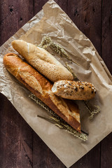 mix of different varieties of bread lying on a wooden table